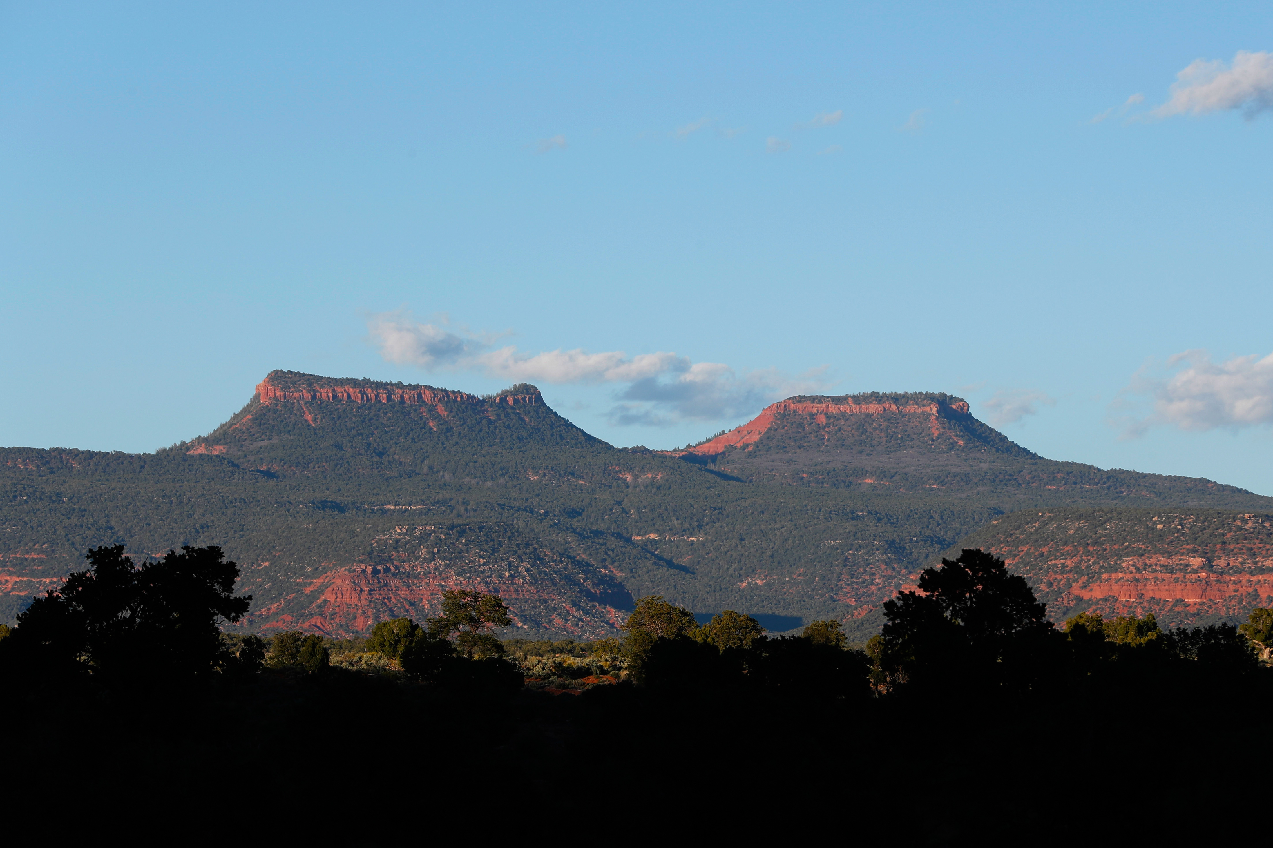 The two bluffs known as the Bears Ears are seen at sunset in the Bears Ears National Monument.