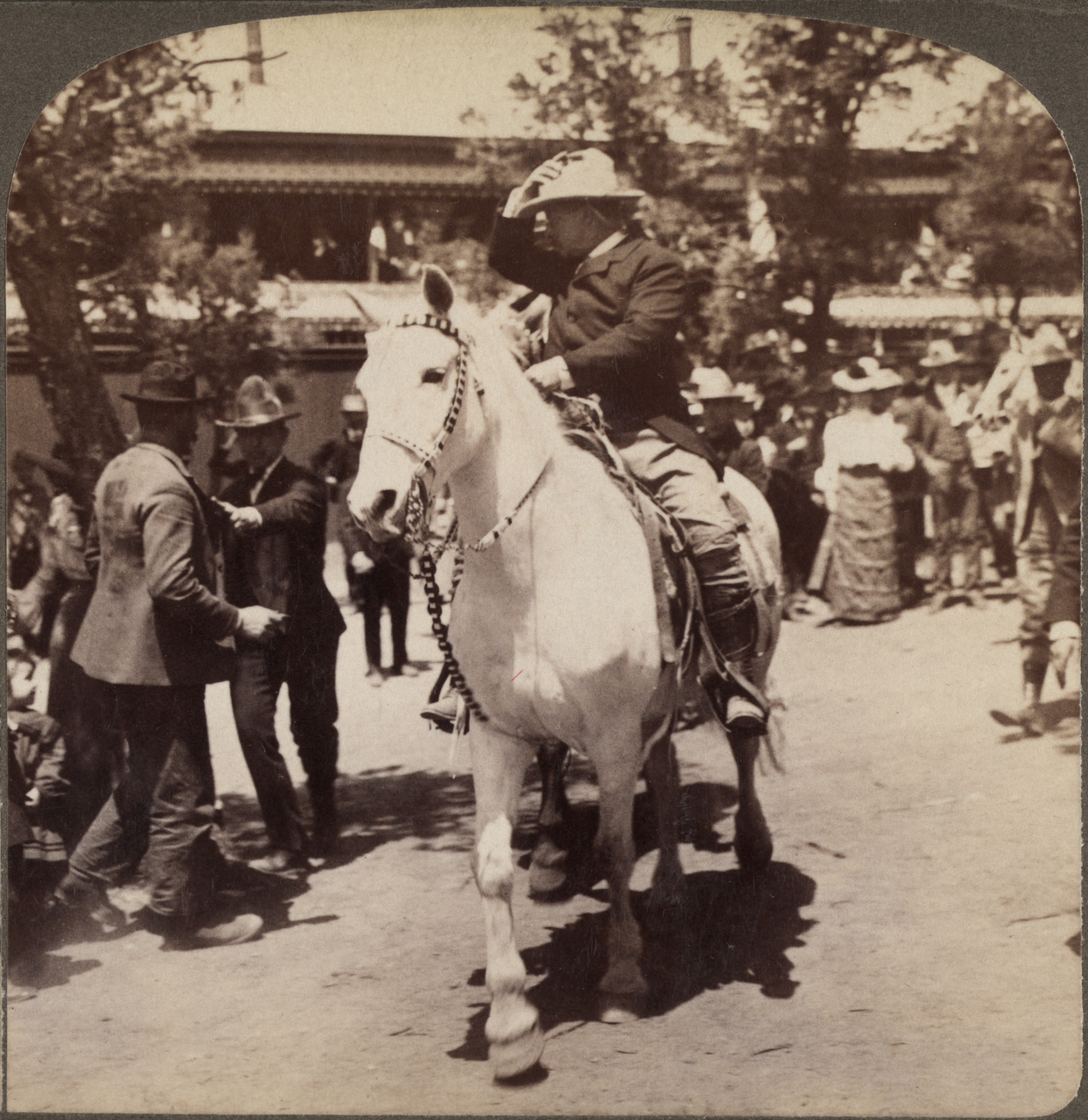 President Theodore Roosevelt rides a horse.