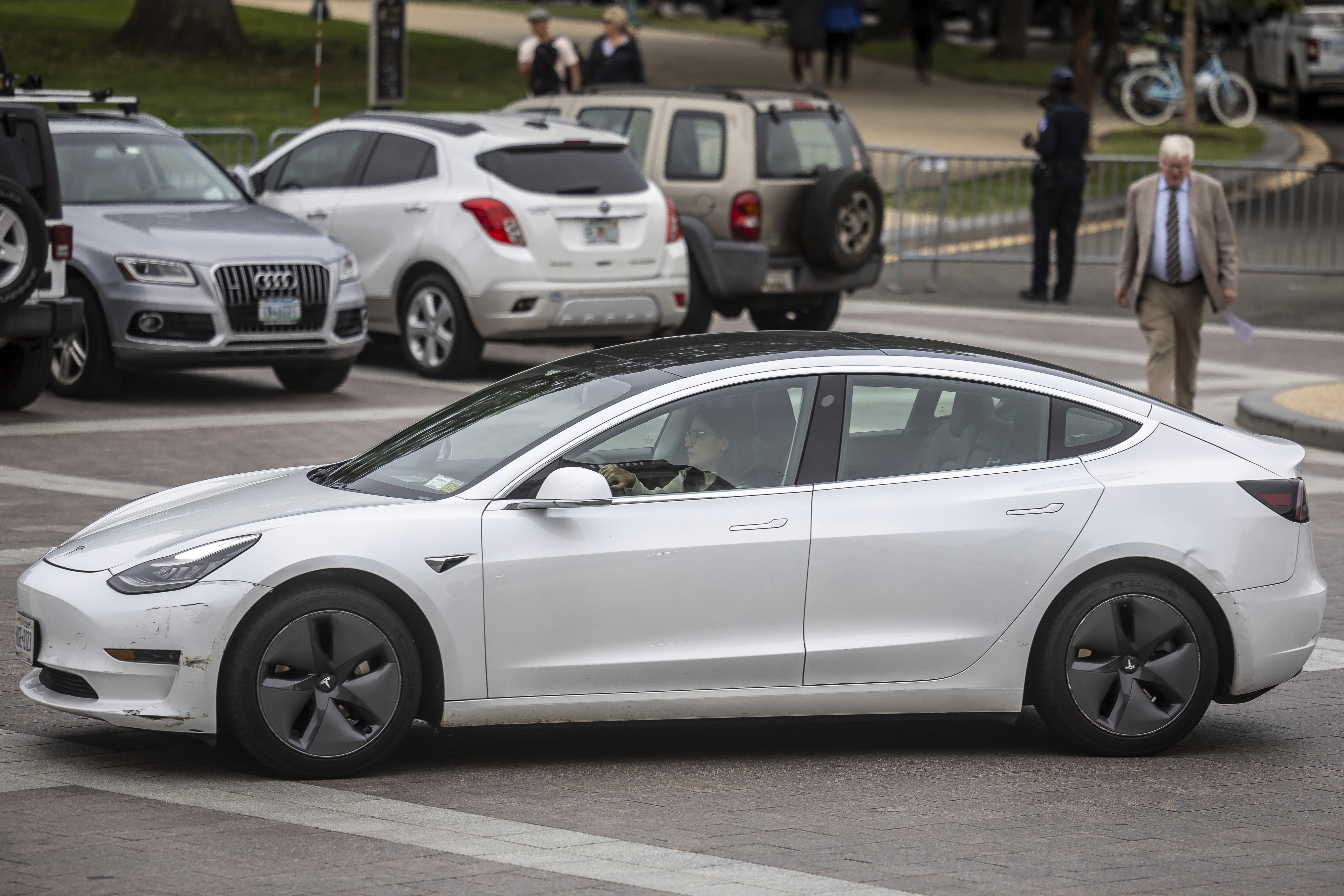 Rep. Alexandria Ocasio-Cortez (D-N.Y.) drives a Tesla electric vehicle as she arrives at the Capitol in 2023. 