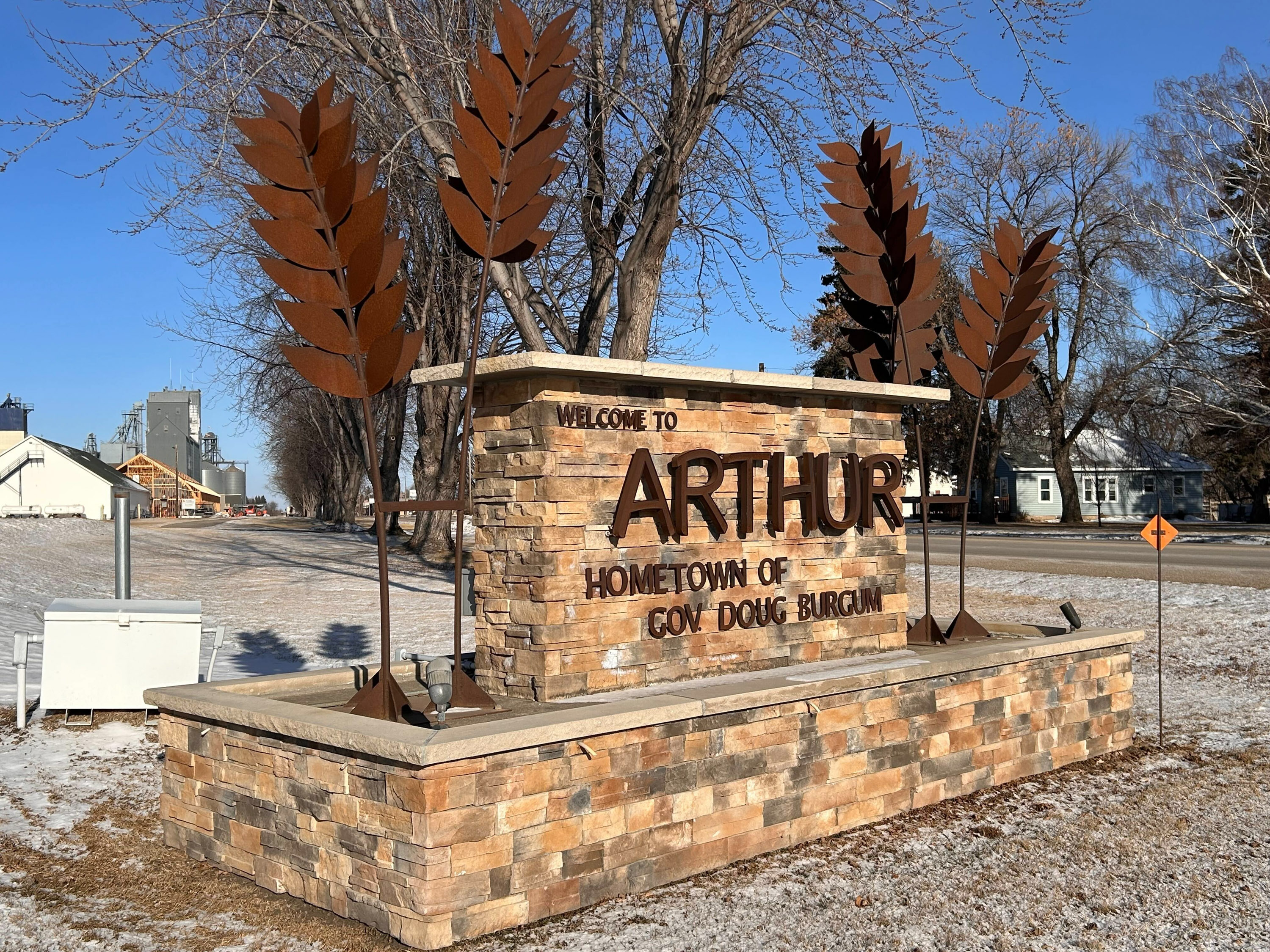 A brick sign that reads: "Welcome to Arthur, Hometown of Gov. Doug Burgum."