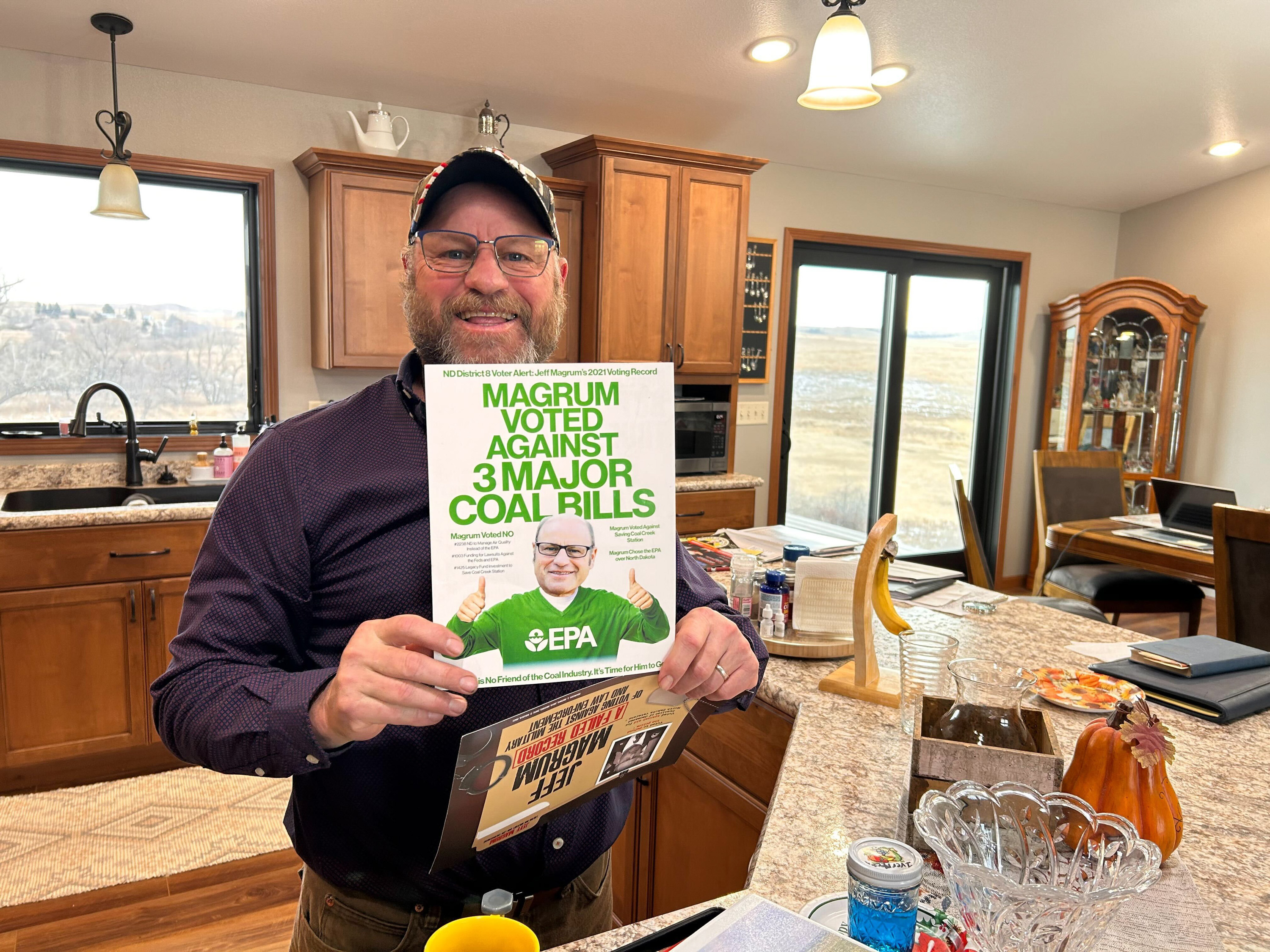 Jeff Magrum holds up mailers.