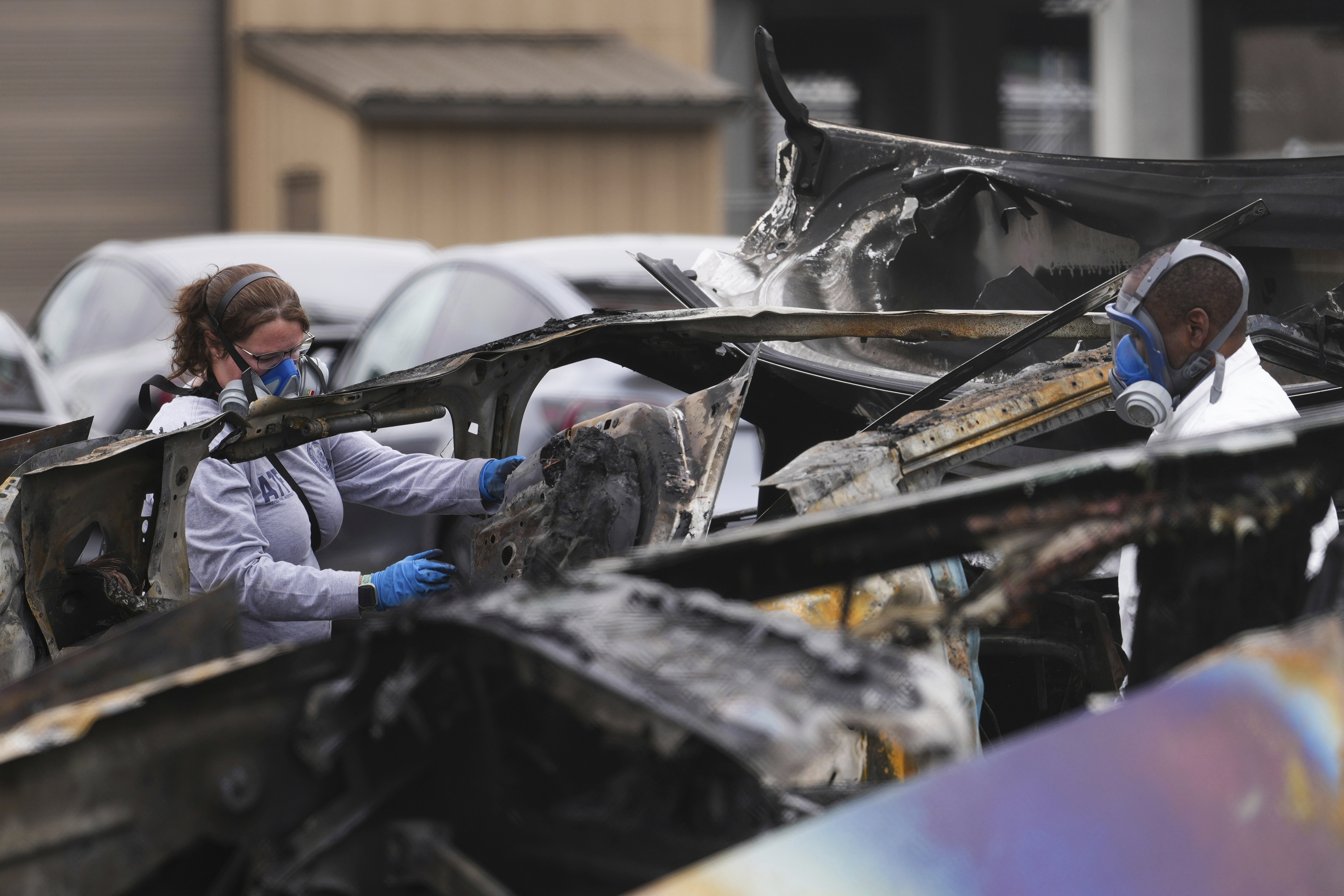 ATF investigators take apart and document a burned Tesla Cybertruck at a Tesla lot in Seattle in March.