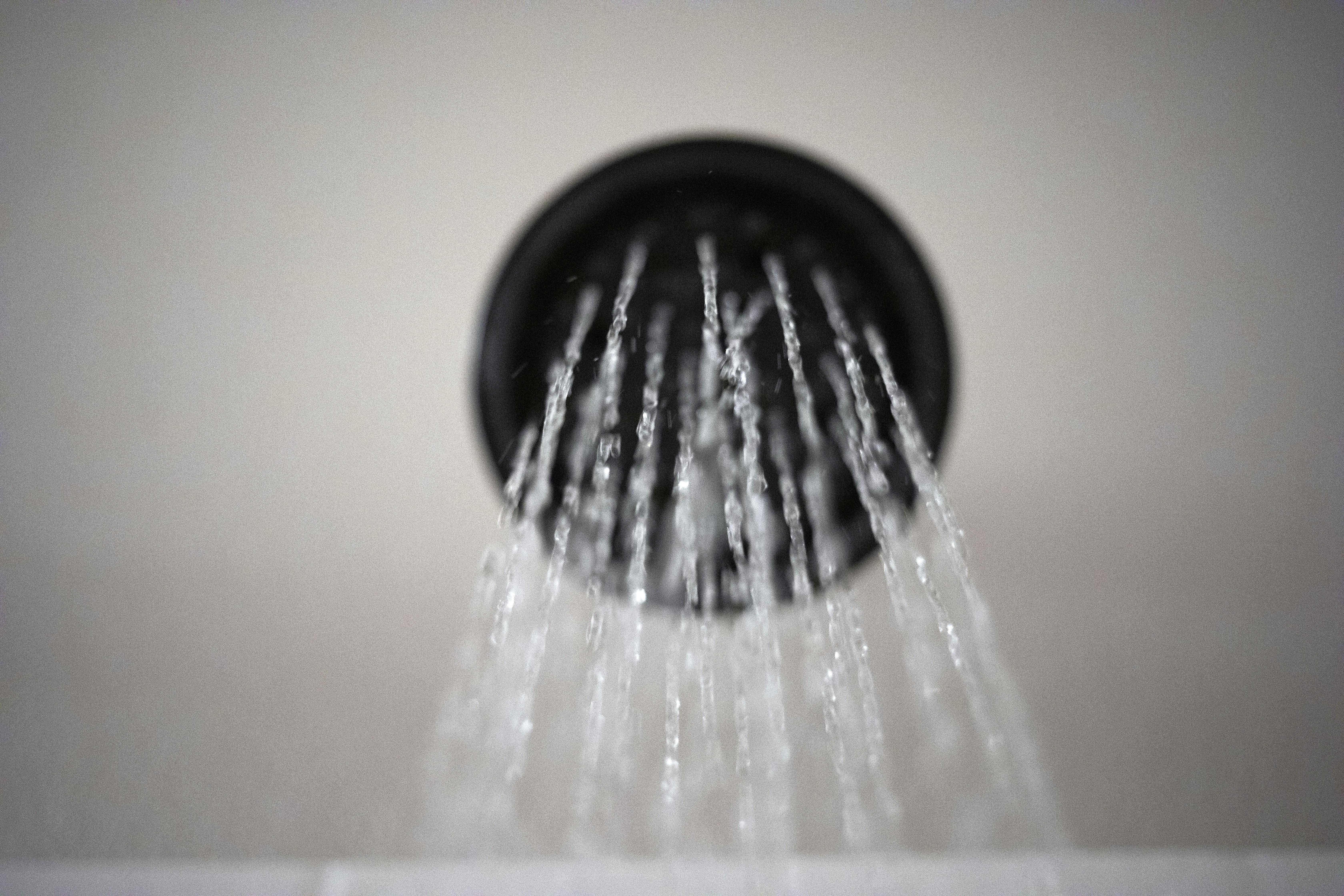 Water flows from a showerhead.
