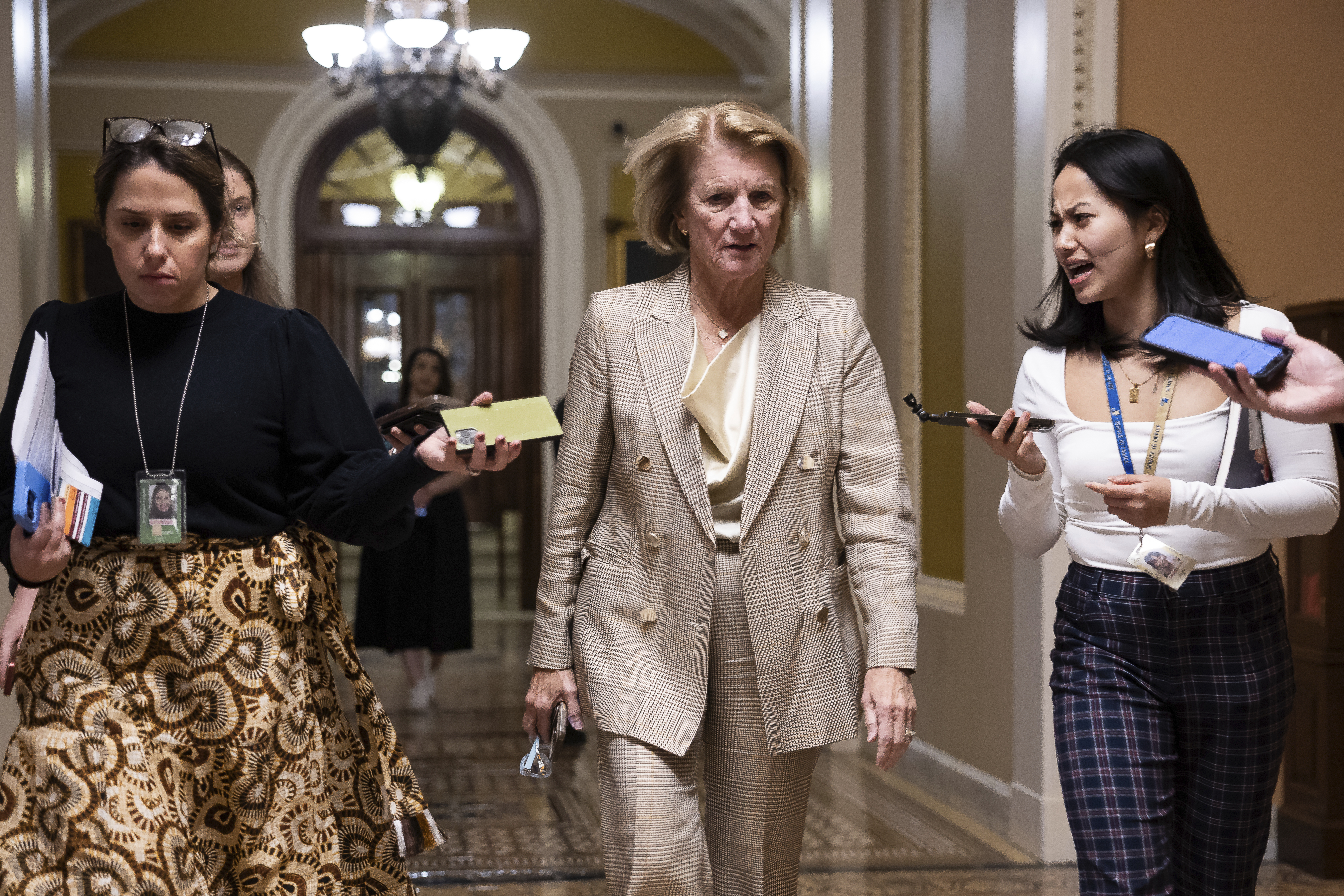 Sen. Shelley Moore Capito (R-W.Va.) speaks with reporters as she walks in the U.S. Capitol. 